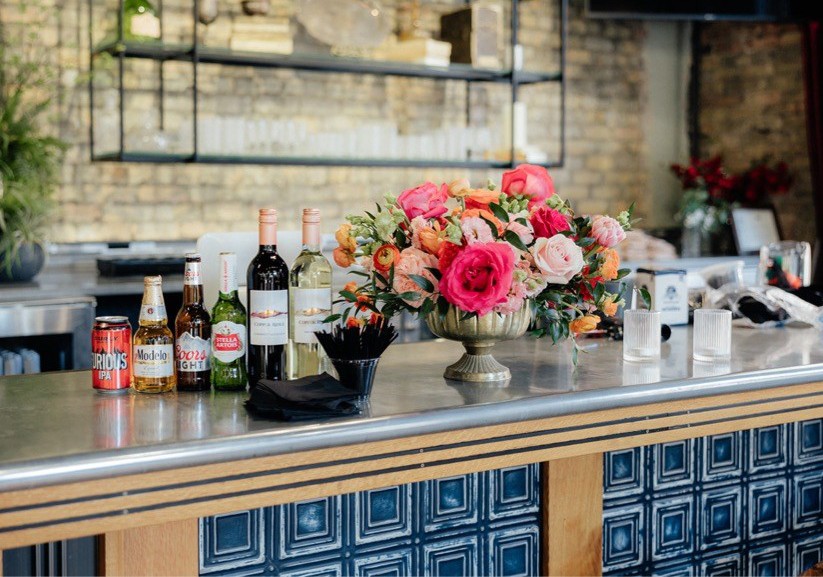 Corporate Events NEW Corporate Event Bar with alcoholic drinks & flowers on the bar